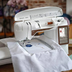 Husqvarna Viking Designer Topaz 40 embroidery machine stitching floral design on fabric using embroidery hoop