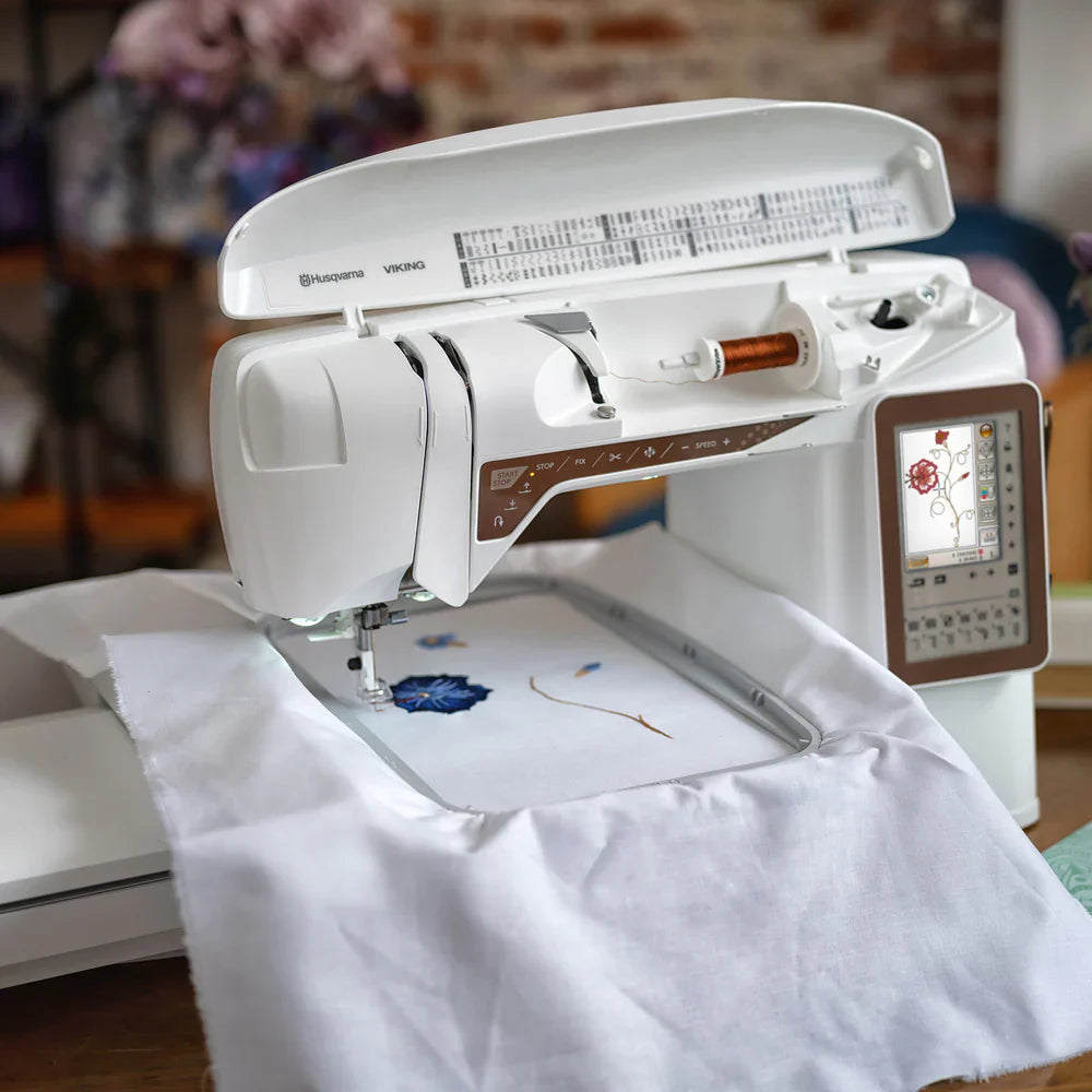 Husqvarna Viking Designer Topaz 40 embroidery machine stitching floral design on fabric using embroidery hoop