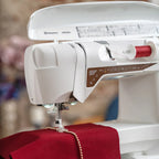 Top view of Husqvarna Viking Designer Topaz 40 sewing machine with open thread compartment and spool holder