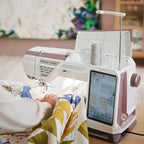 Side view of the Husqvarna Viking EPIC QUILT 97 sewing machine quilting layered fabric with intuitive touch screen controls