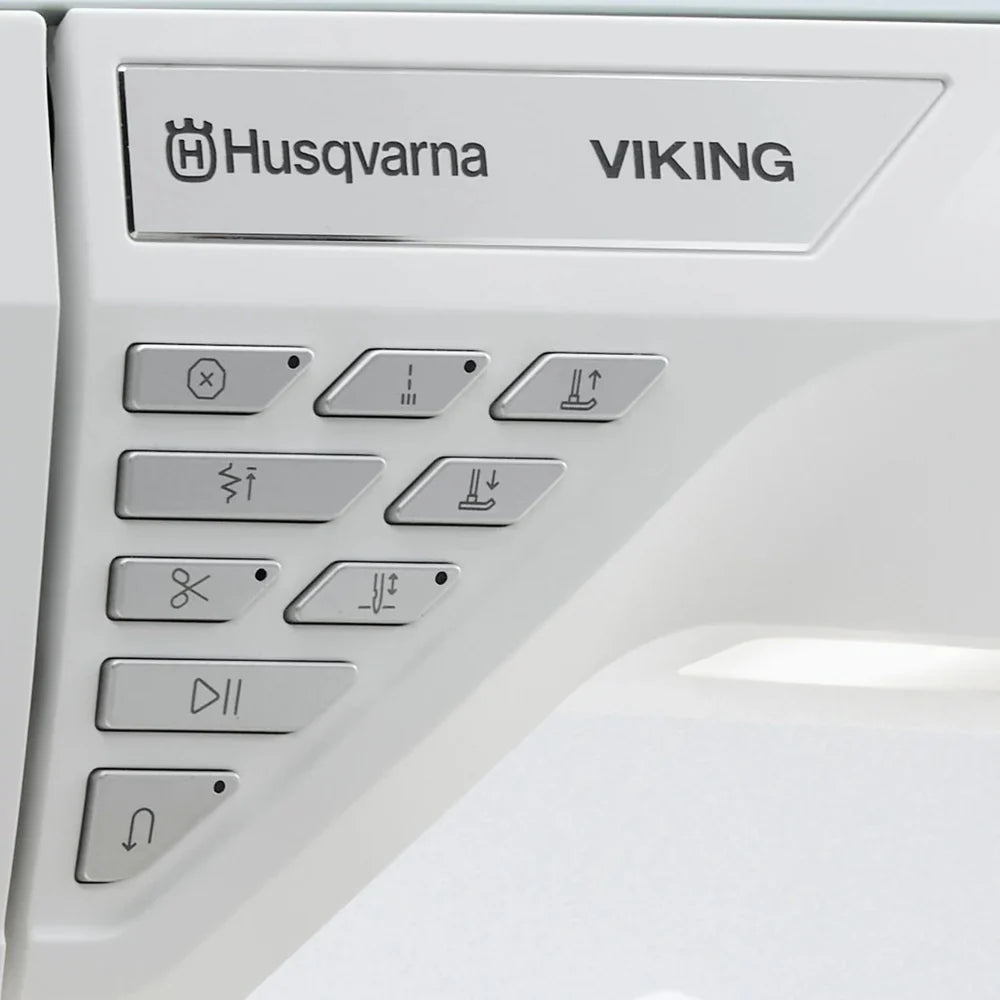 Husqvarna Viking Designer Topaz 65 sewing machine control buttons and brand logo close-up