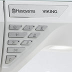 Husqvarna Viking Designer Topaz 65 sewing machine control buttons and brand logo close-up