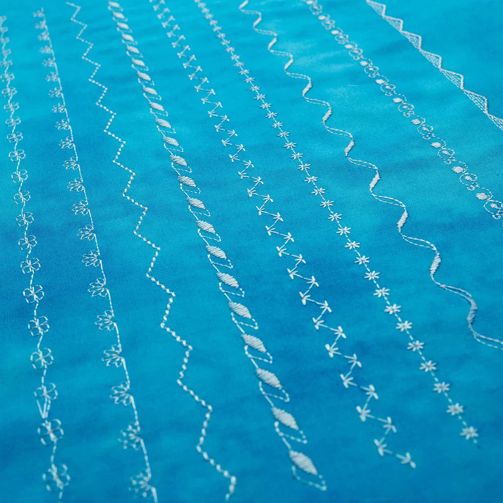 Decorative stitch samples sewn with the Husqvarna Viking Opal 670 showing multiple stitch patterns on blue fabric
