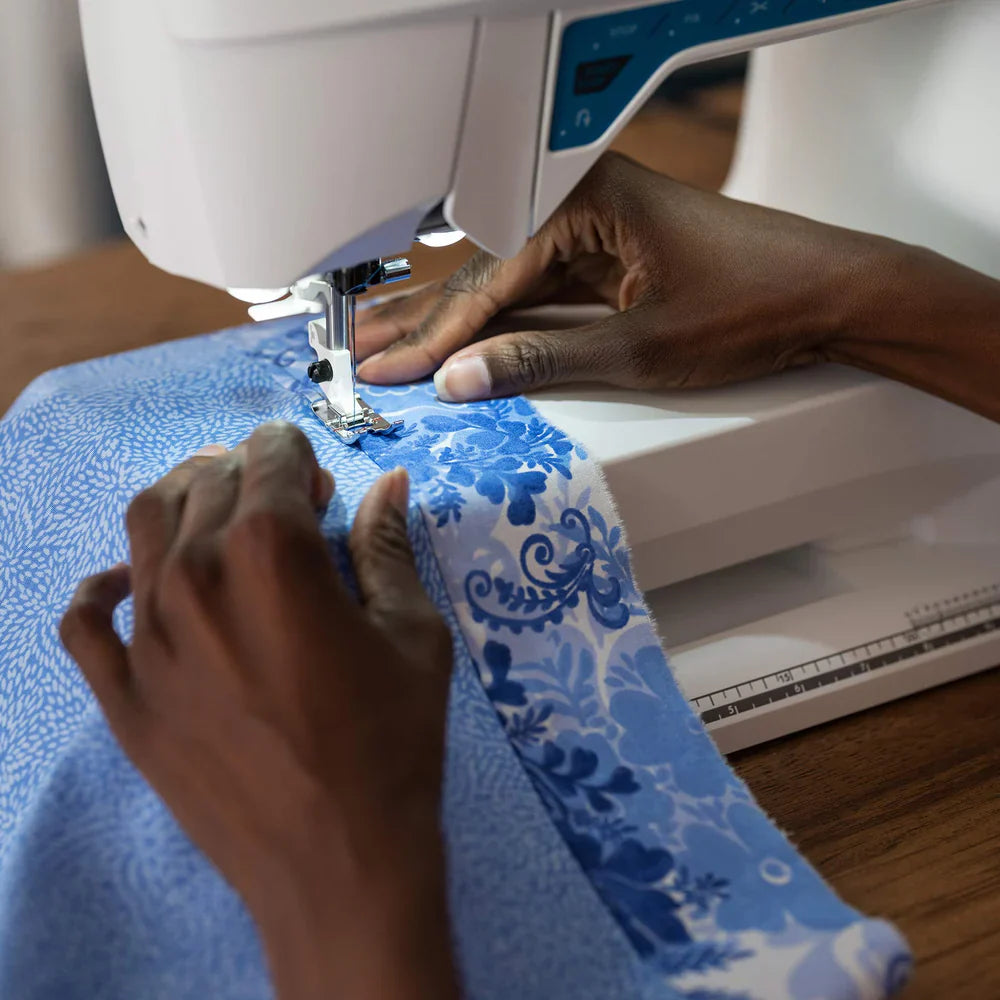 Close-up of fabric being sewn with the Husqvarna Viking Opal 670 sewing machine needle and presser foot