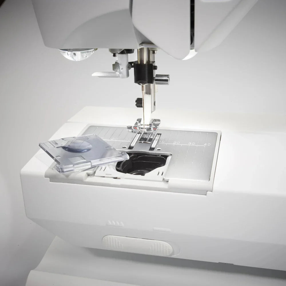 Husqvarna Viking Opal 670 sewing machine needle plate and top-loading bobbin area with LED lighting