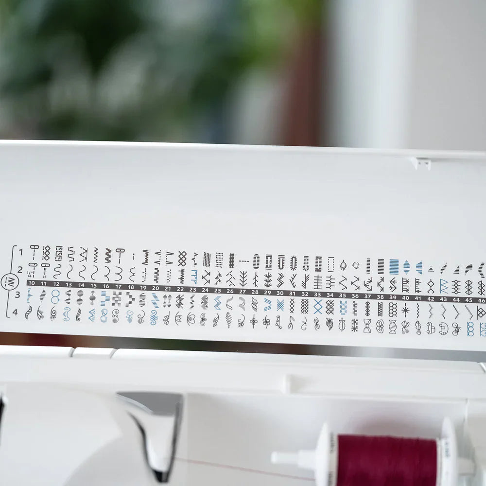 Built-in stitch chart inside Husqvarna Viking Sapphire 930 sewing machine lid displaying over 200 utility and decorative stitches