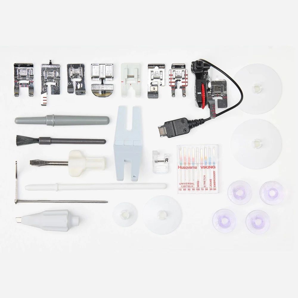 Husqvarna Viking Topaz 55Q sewing machine accessories including presser feet, bobbins, needles, tools, and power cable