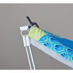 Close-up of a black clamp attaching a quilt edge to a white Weightless Quilter support pole.